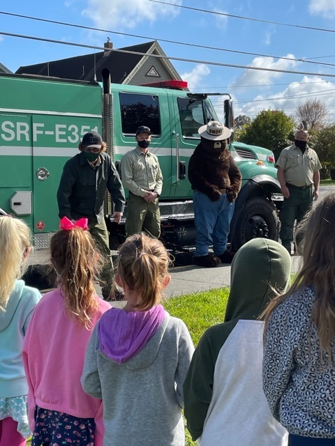 Image of students with Smokey Bear